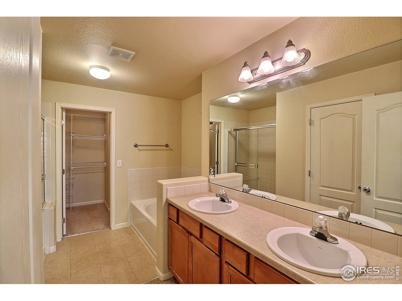 5600 West 3rd Street, Unit 4 Greeley, CO 80634 - Photo 22 of 32 a bathroom with a sink double vanity granite and a mirror