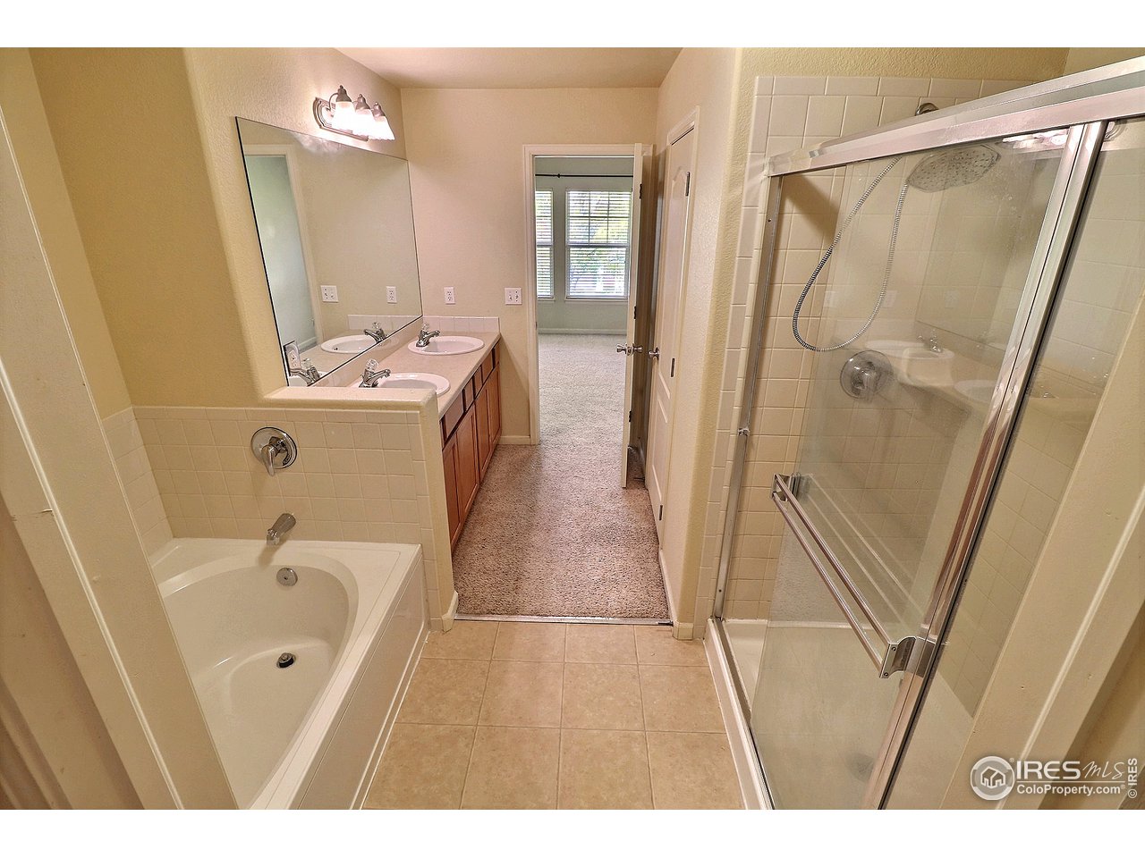 5600 West 3rd Street, Unit 4 Greeley, CO 80634 - Photo 23 of 32 a bathroom with a tub sink and mirror