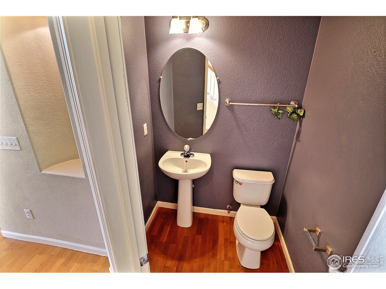 5600 West 3rd Street, Unit 4 Greeley, CO 80634 - Photo 5 of 32 a bathroom with a toilet a sink and a mirror