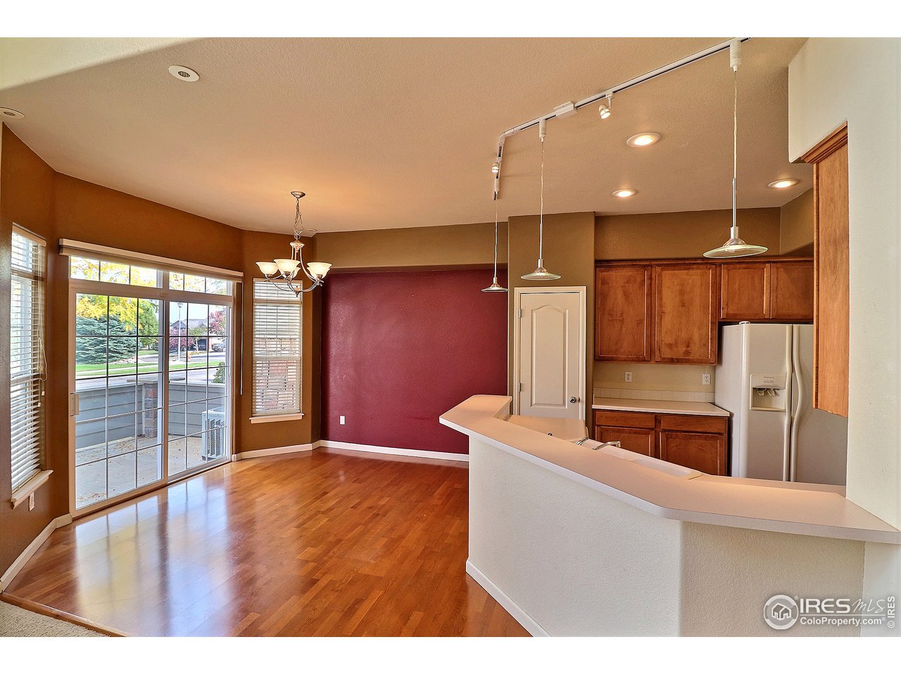 5600 West 3rd Street, Unit 4 Greeley, CO 80634 - Photo 9 of 32 a kitchen with stainless steel appliances kitchen island wooden floors and large window