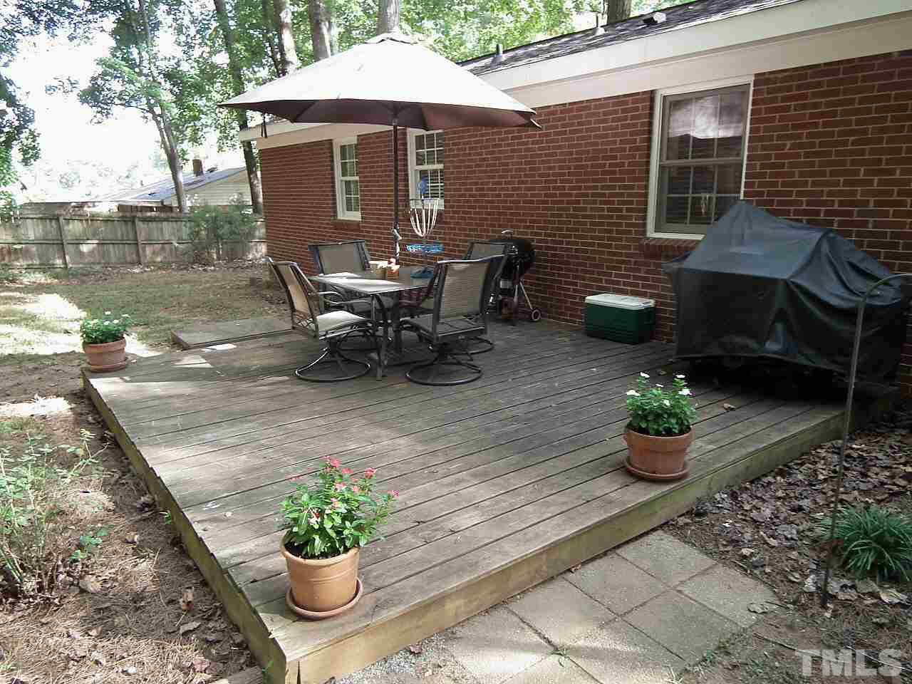 2824 Oak Ridge Court Raleigh, NC 27603 - Photo 13 of 22 a backyard of a house with a yard and outdoor seating