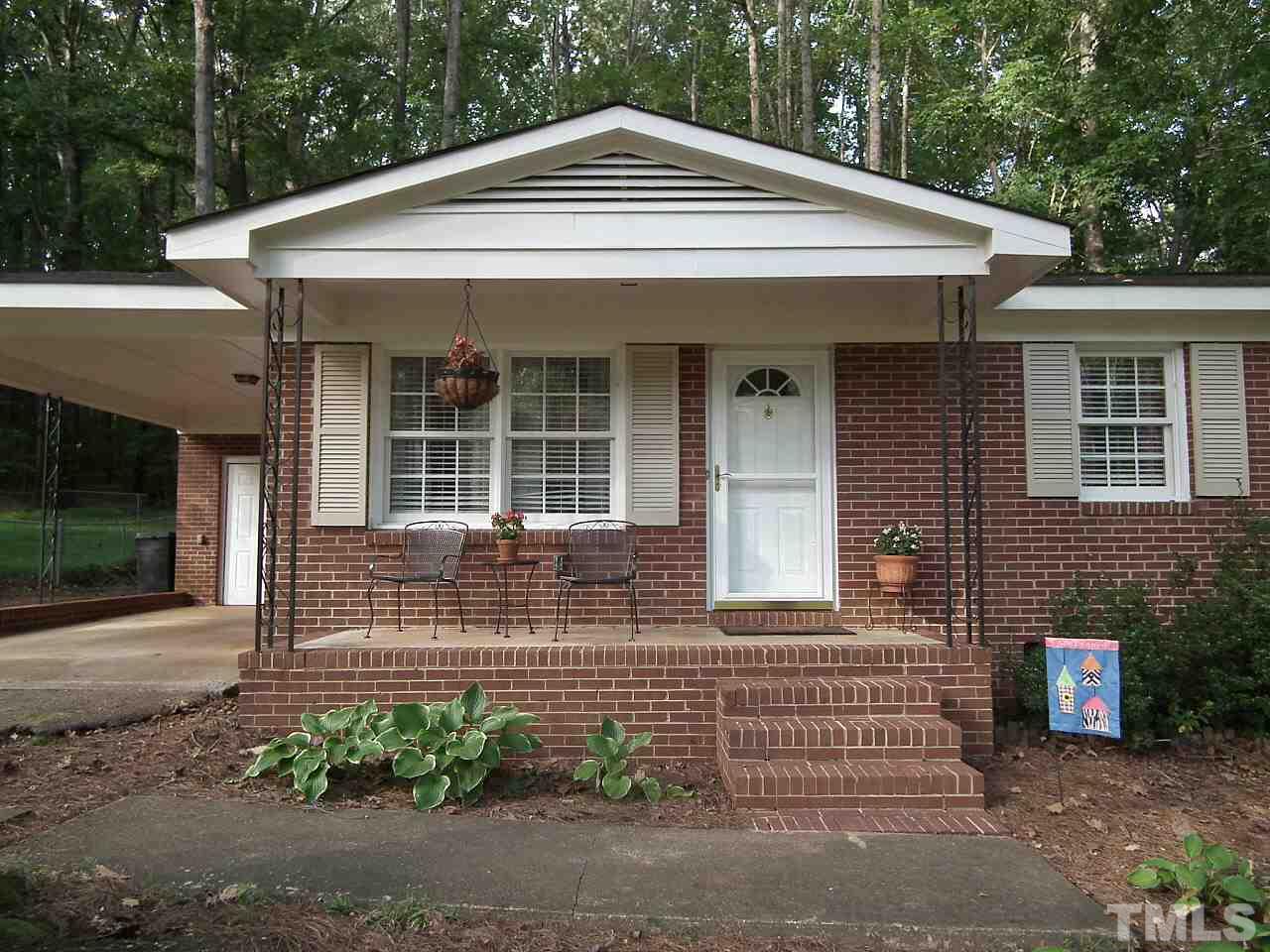 2824 Oak Ridge Court Raleigh, NC 27603 - Photo 20 of 22 a front view of a house with garden