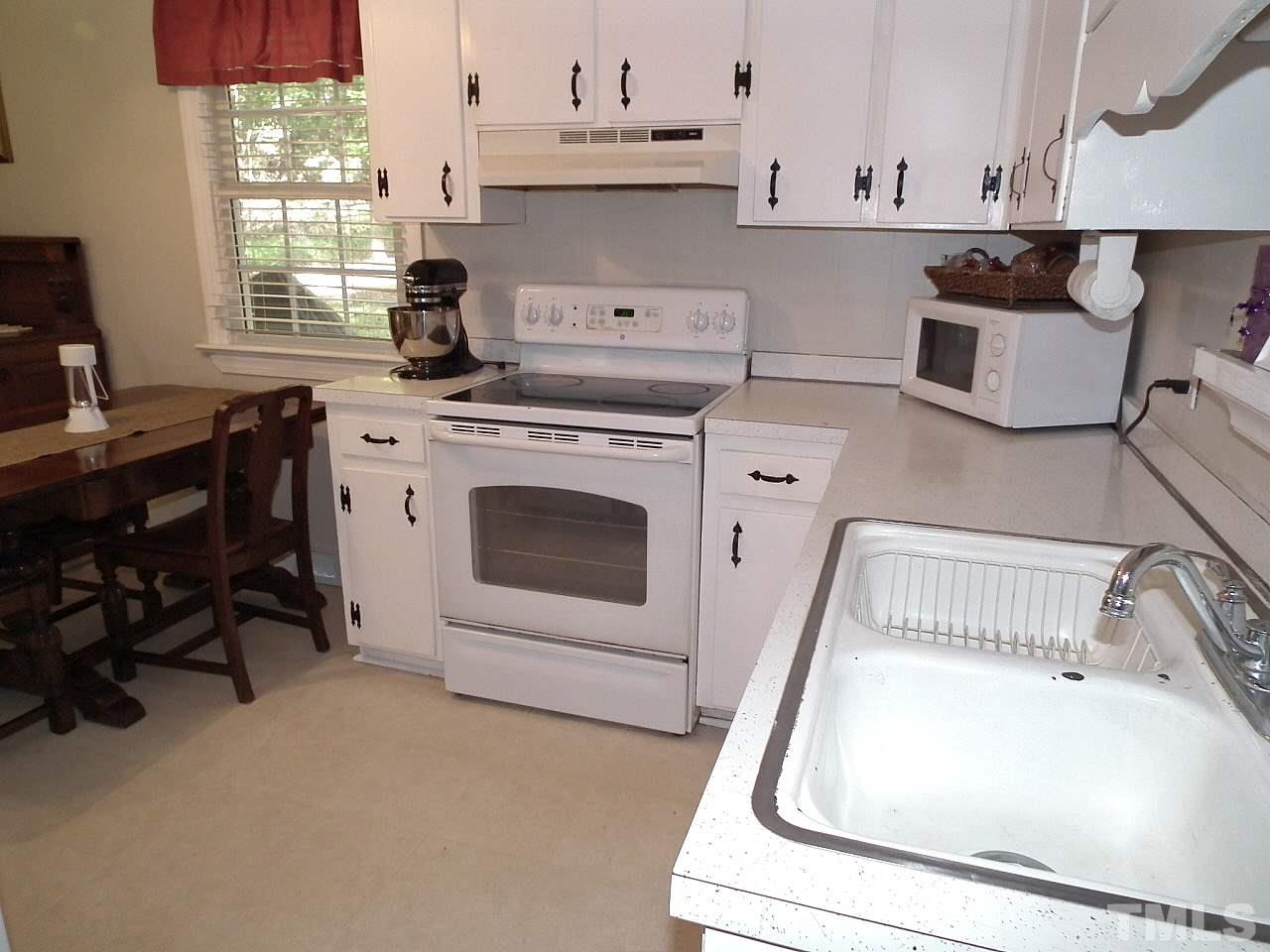 2824 Oak Ridge Court Raleigh, NC 27603 - Photo 3 of 22 a kitchen with a sink stove and cabinets