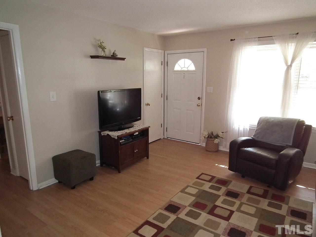 2824 Oak Ridge Court Raleigh, NC 27603 - Photo 7 of 22 a living room with furniture and a flat screen tv