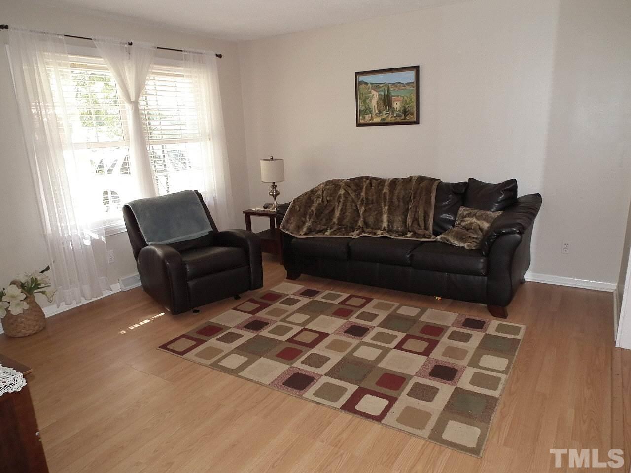 2824 Oak Ridge Court Raleigh, NC 27603 - Photo 9 of 22 a living room with furniture and a flat screen tv