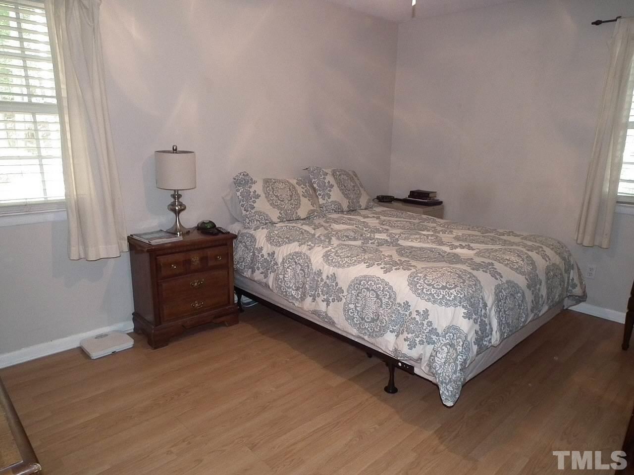 2824 Oak Ridge Court Raleigh, NC 27603 - Photo 10 of 22 a bed sitting in a bedroom next to a window