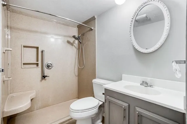 an empty room with closet and a chandelier fan