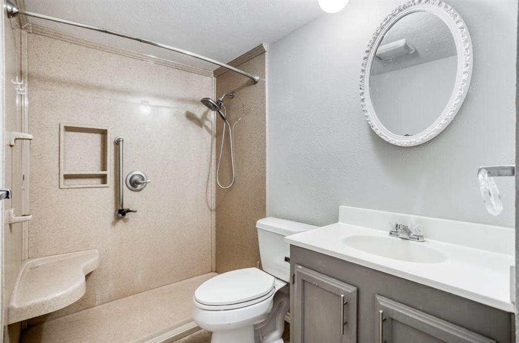 5656 Pearce Street The Colony, TX 75056 - Photo 12 of 23 a bathroom with a sink a toilet and a mirror