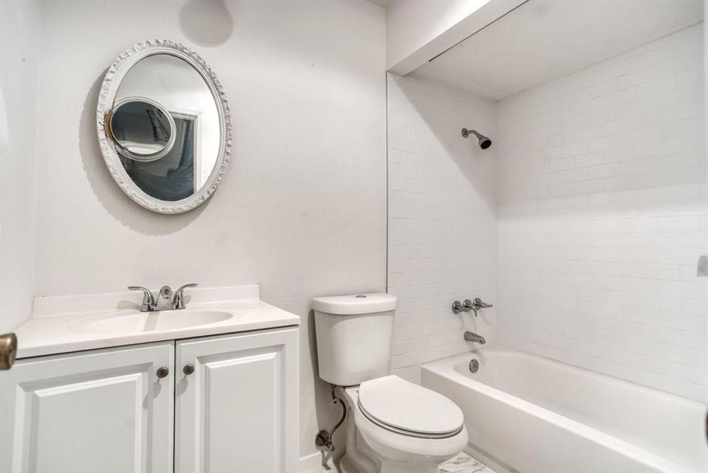 5656 Pearce Street The Colony, TX 75056 - Photo 15 of 23 a bathroom with a sink a toilet and a mirror
