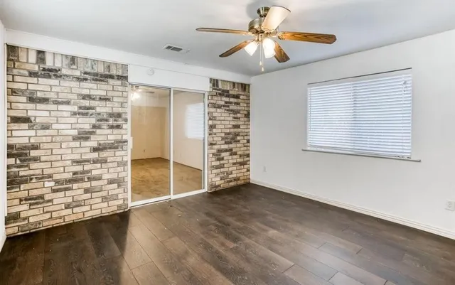a view of a yard with wooden fence