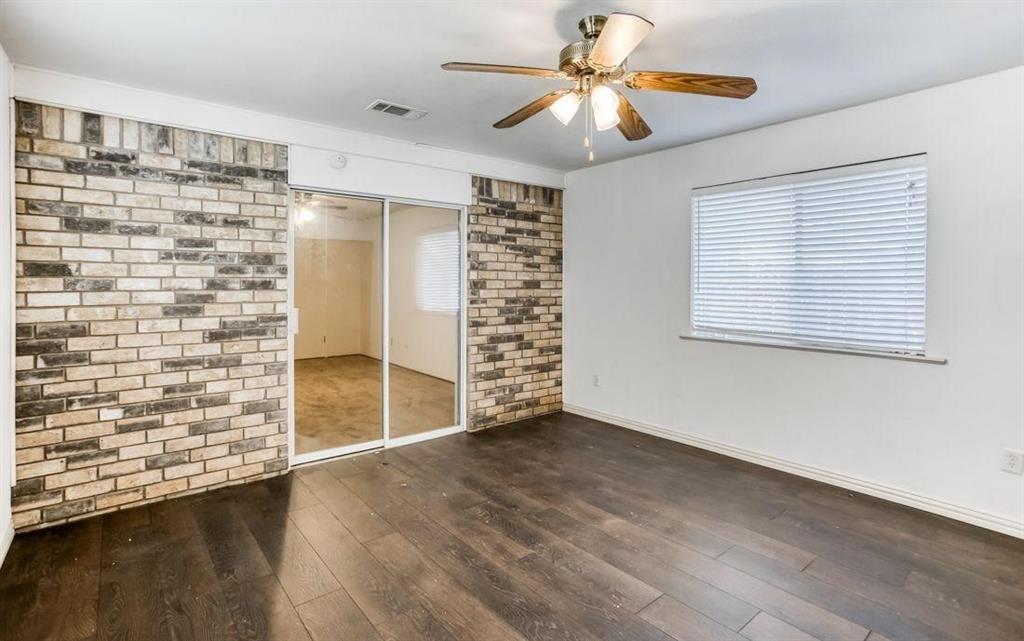 5656 Pearce Street The Colony, TX 75056 - Photo 18 of 23 a view of an empty room with a window and wooden floor