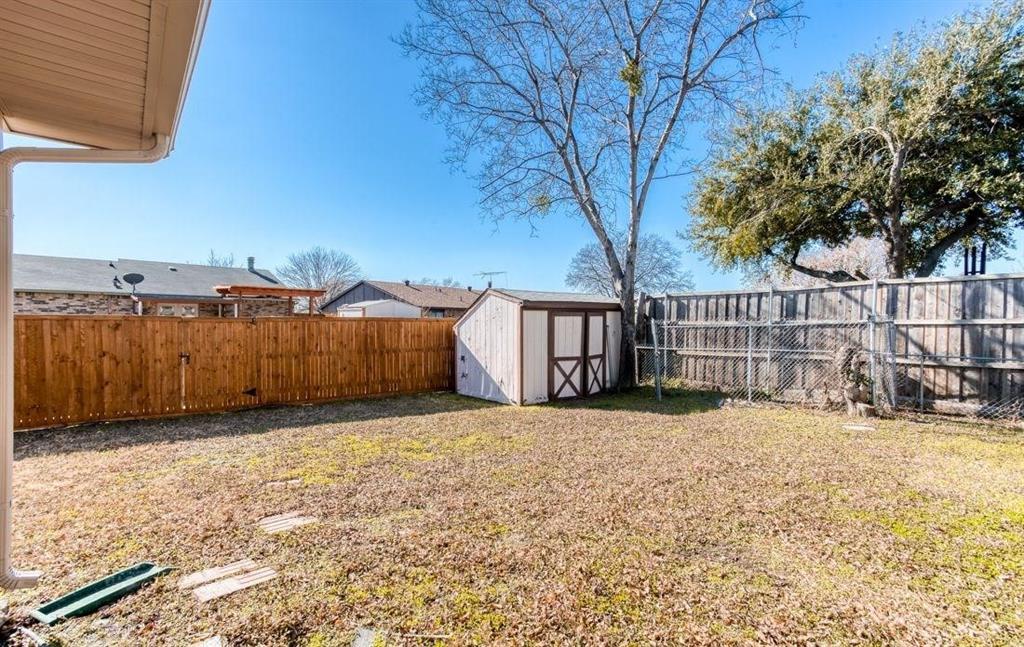 5656 Pearce Street The Colony, TX 75056 - Photo 19 of 23 a view of a yard with wooden fence