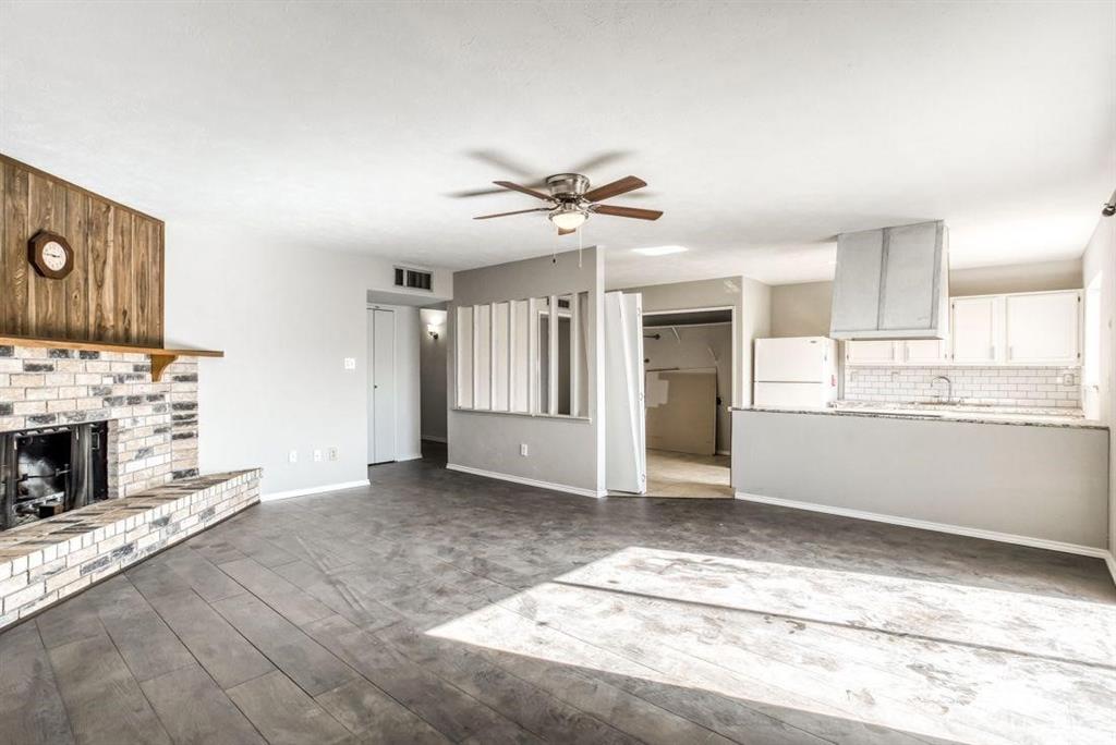 5656 Pearce Street The Colony, TX 75056 - Photo 3 of 23 a view of a kitchen with an empty room and fire place