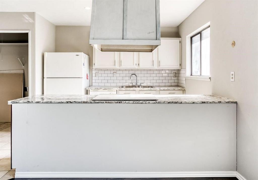 5656 Pearce Street The Colony, TX 75056 - Photo 4 of 23 a kitchen with granite countertop a sink and a stove