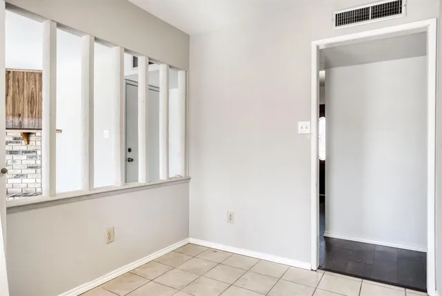 a view of a bedroom with wooden floor and windows