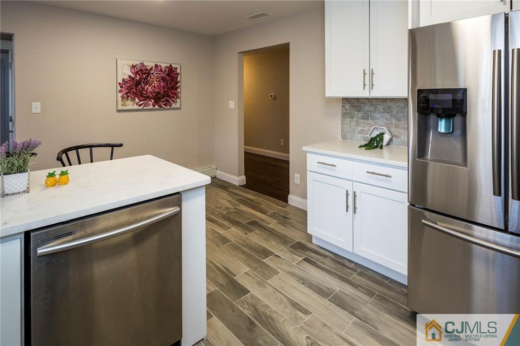 66 Middlesex Road Matawan, NJ 07747 - Photo 11 of 22 a kitchen with stainless steel appliances a refrigerator sink and stove