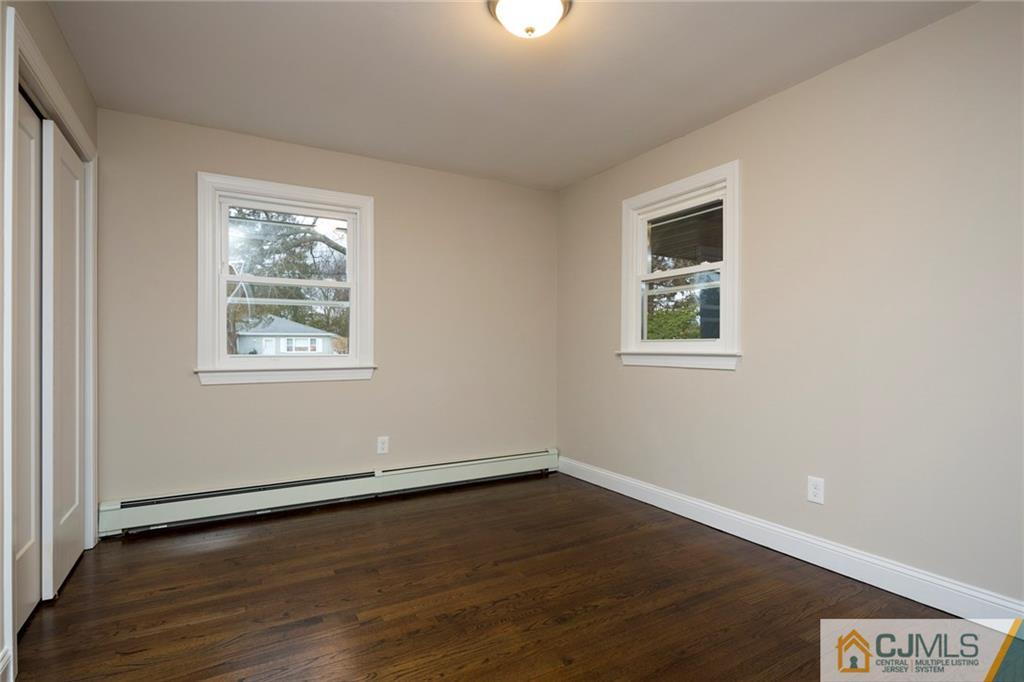 66 Middlesex Road Matawan, NJ 07747 - Photo 13 of 22 a view of an empty room with wooden floor and a window