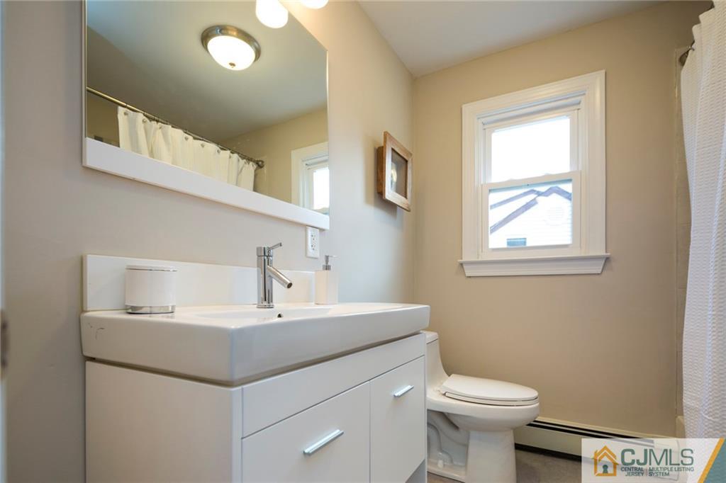 66 Middlesex Road Matawan, NJ 07747 - Photo 14 of 22 a bathroom with a sink toilet and a mirror