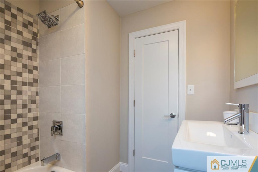 66 Middlesex Road Matawan, NJ 07747 - Photo 15 of 22 a bathroom with a sink and a tub