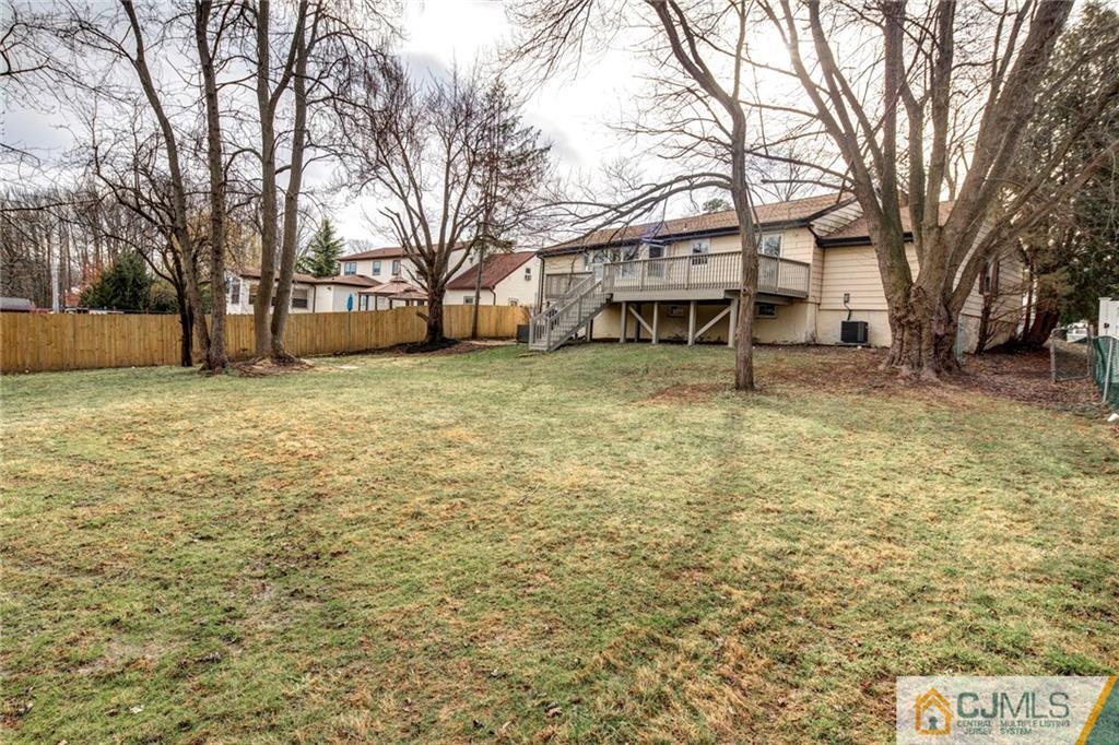 66 Middlesex Road Matawan, NJ 07747 - Photo 21 of 22 a white house that has a tree in front of it