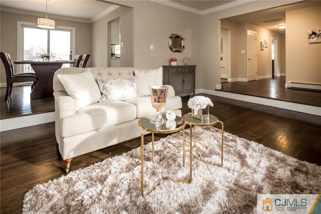 66 Middlesex Road Matawan, NJ 07747 - Photo 6 of 22 a living room with furniture and a large mirror next to a window