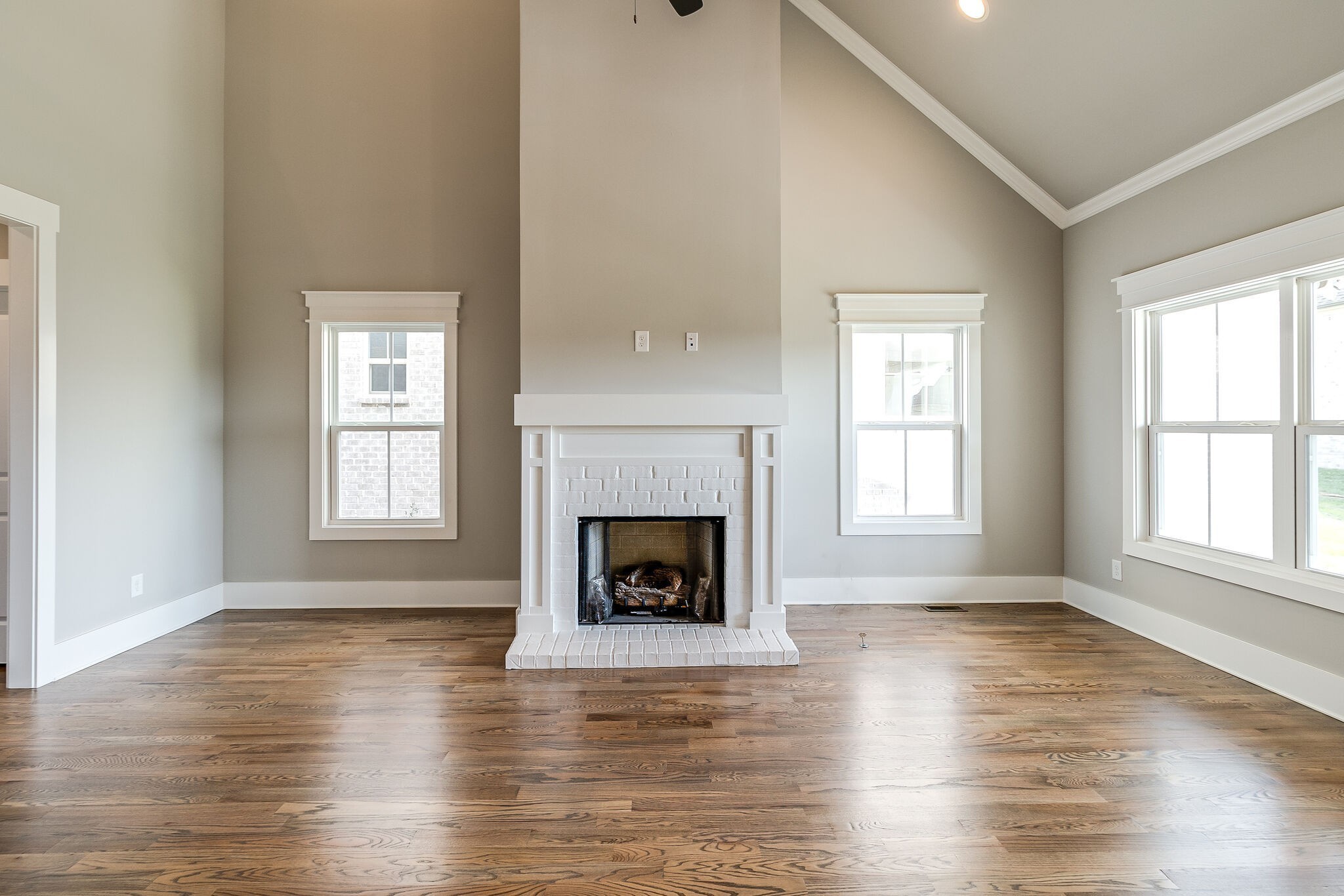 3003 Turnstone Trace Spring Hill, TN 37174 - Photo 6 of 26 an empty room with wooden floor fireplace and windows