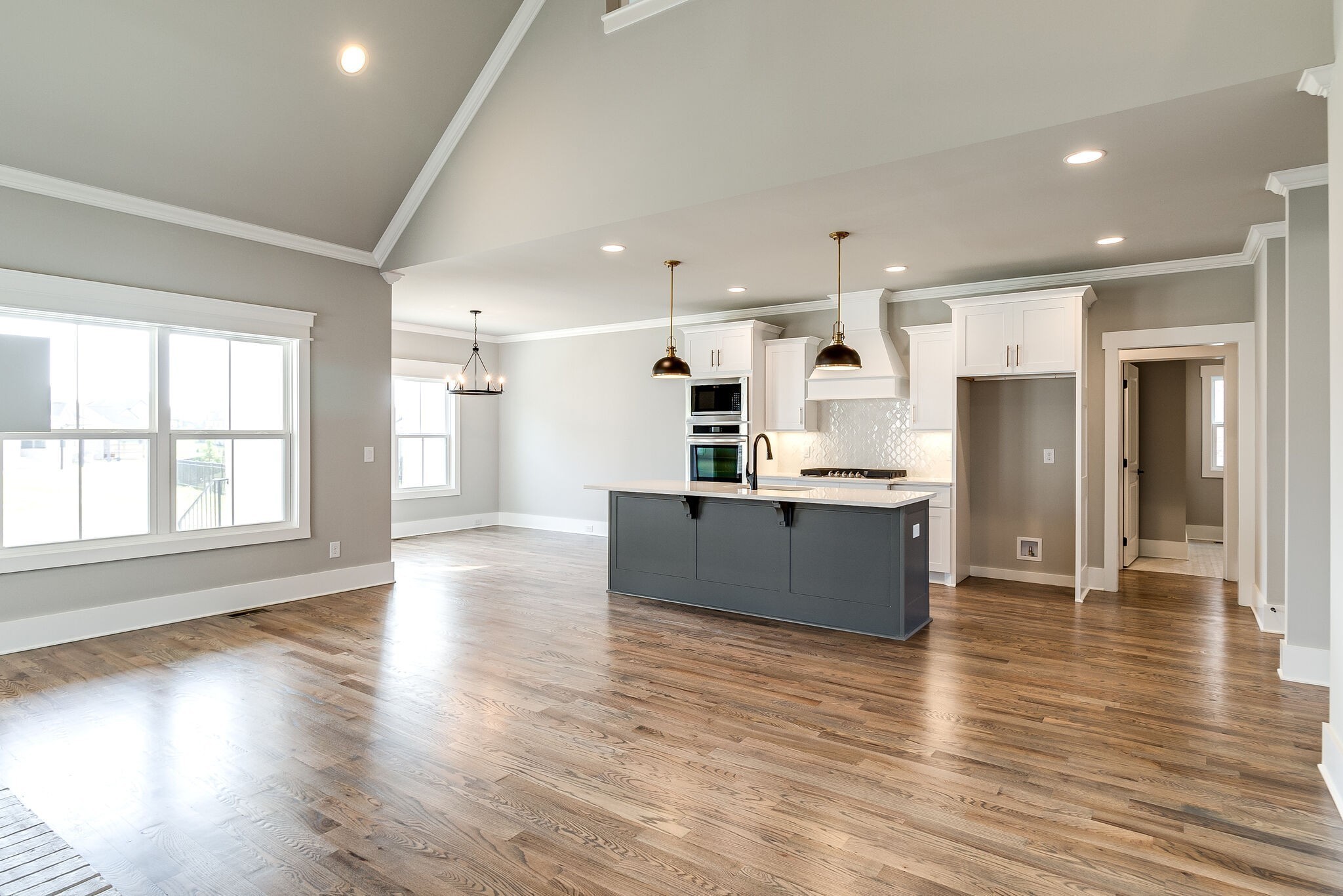3003 Turnstone Trace Spring Hill, TN 37174 - Photo 8 of 26 an open kitchen with kitchen island wooden floors and stainless steel appliances