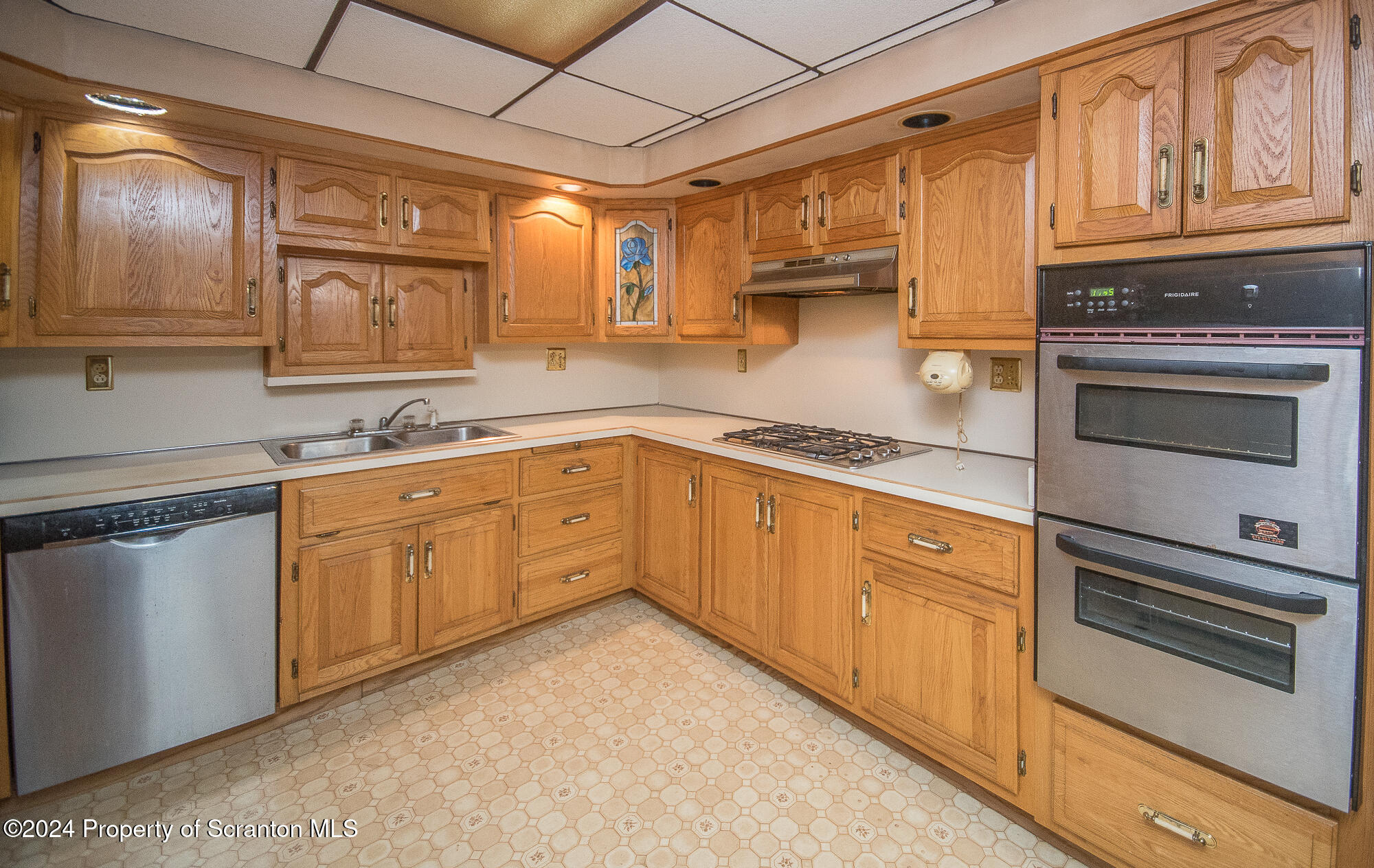 225 East Mountain Road Scranton, PA 18505 - Photo 12 of 44 a kitchen with cabinets appliances a sink and a window