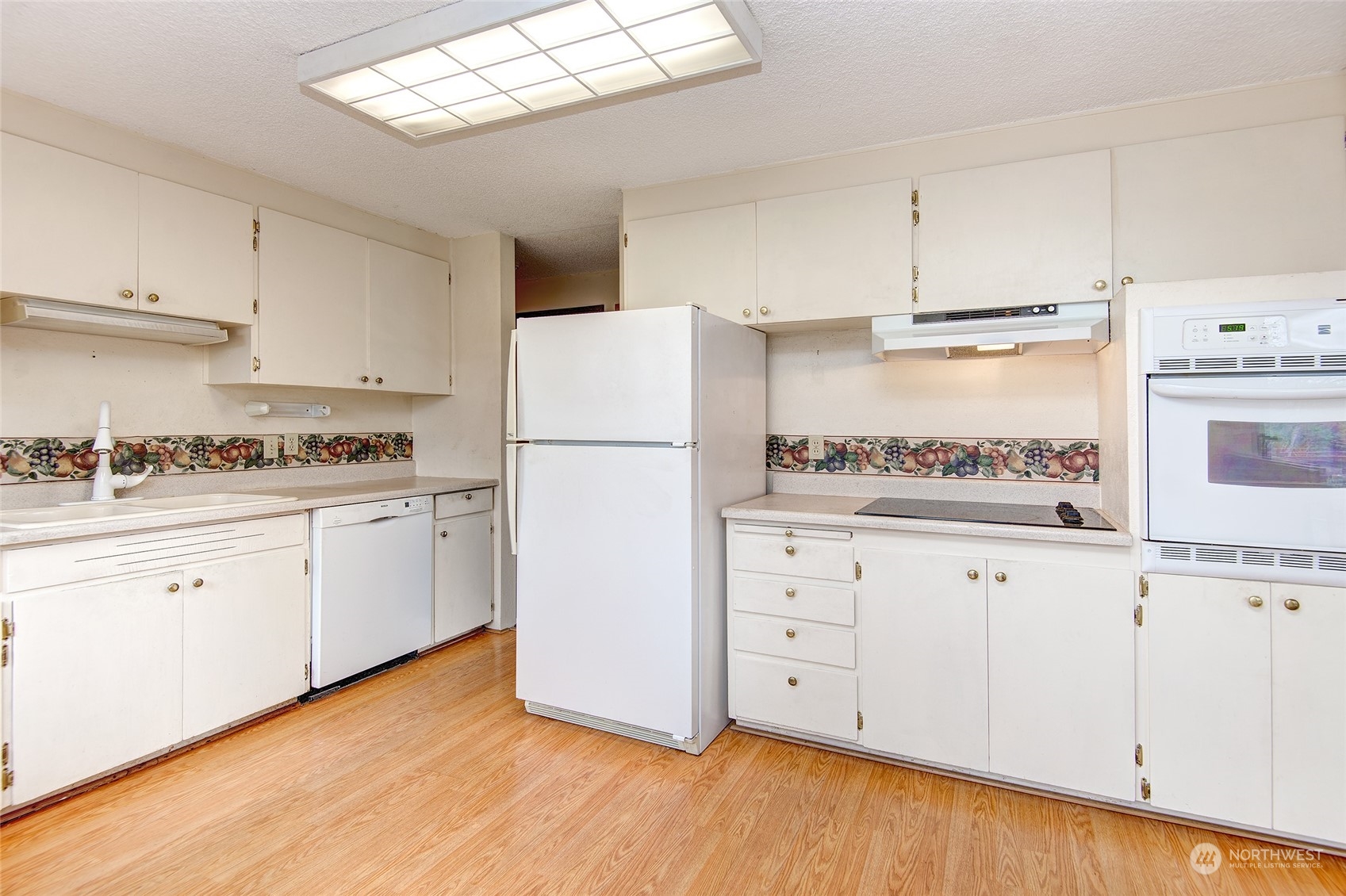24318 7th Avenue West Bothell, WA 98021 - Photo 5 of 19 a kitchen with granite countertop white cabinets and white appliances