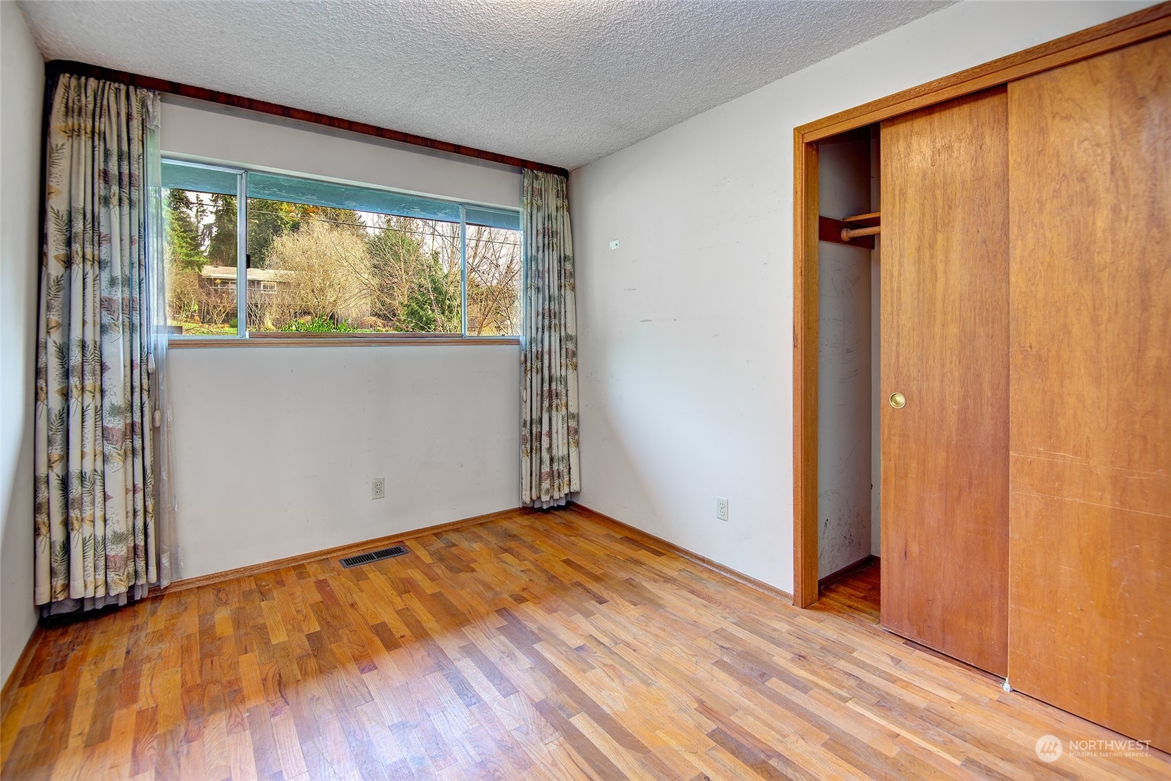 24318 7th Avenue West Bothell, WA 98021 - Photo 8 of 19 an empty room with wooden floor and windows