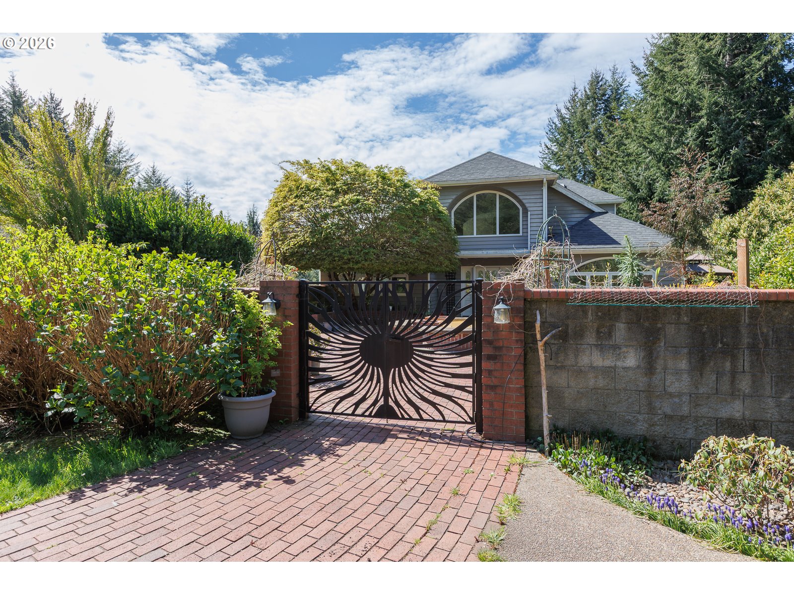 626 North Bayview Loop Waldport, OR 97394 - Photo 2 of 38 a front view of house with a garden