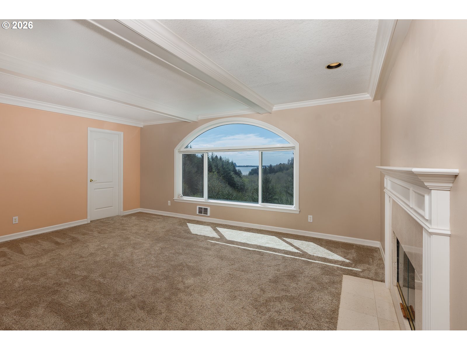 626 North Bayview Loop Waldport, OR 97394 - Photo 21 of 38 a view of an empty room with a fireplace and a window