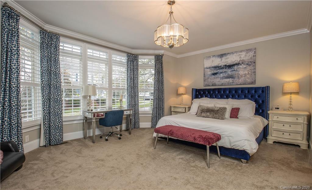 728 Shady Grove Crossing Fort Mill, SC 29708 - Photo 15 of 41 a bedroom with a bed and a chandelier