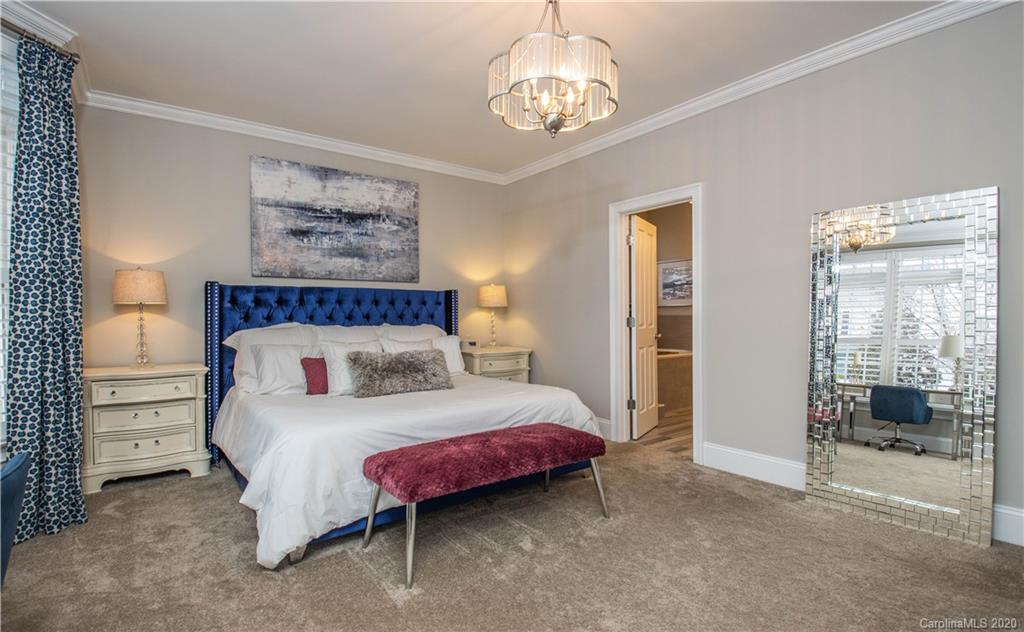 728 Shady Grove Crossing Fort Mill, SC 29708 - Photo 16 of 41 a bedroom with a bed and a chandelier