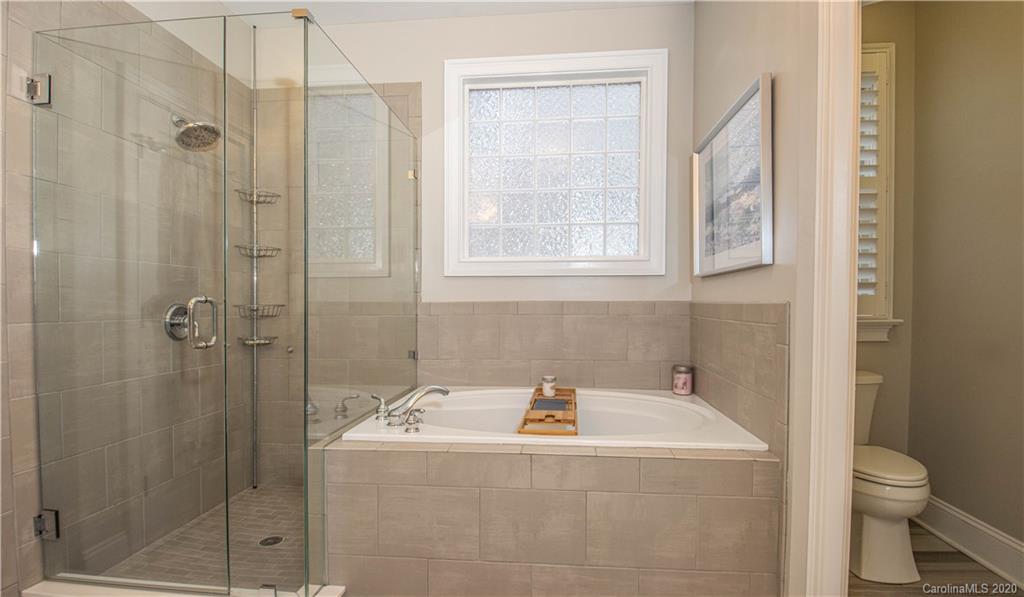 728 Shady Grove Crossing Fort Mill, SC 29708 - Photo 18 of 41 a bathroom with a granite countertop sink toilet and shower