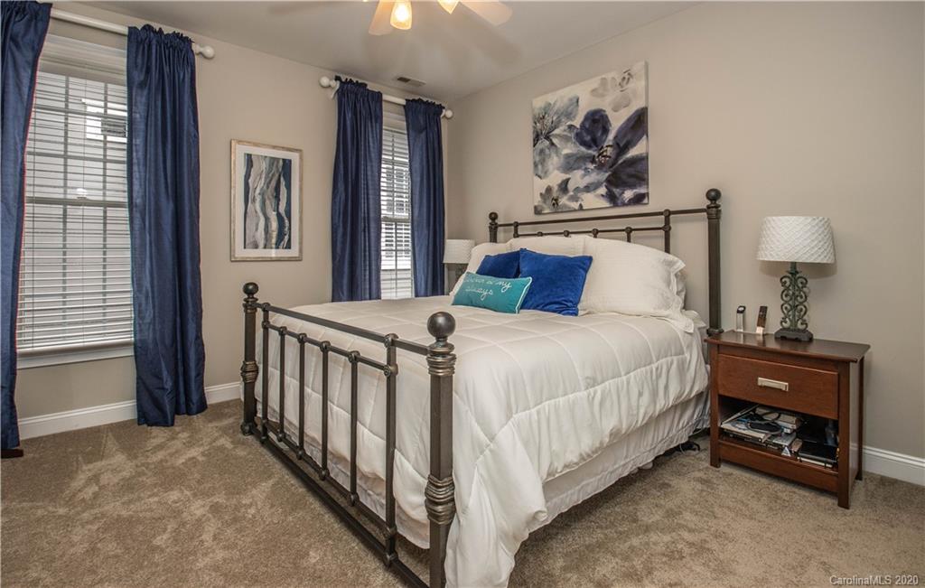 728 Shady Grove Crossing Fort Mill, SC 29708 - Photo 22 of 41 a bedroom with a bed and a lamp on dresser