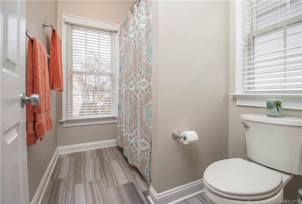 728 Shady Grove Crossing Fort Mill, SC 29708 - Photo 25 of 41 a white toilet sitting next to a bathroom sink and tub