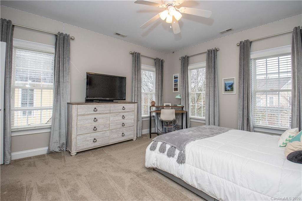 728 Shady Grove Crossing Fort Mill, SC 29708 - Photo 27 of 41 a spacious bedroom with a bed and wooden floor