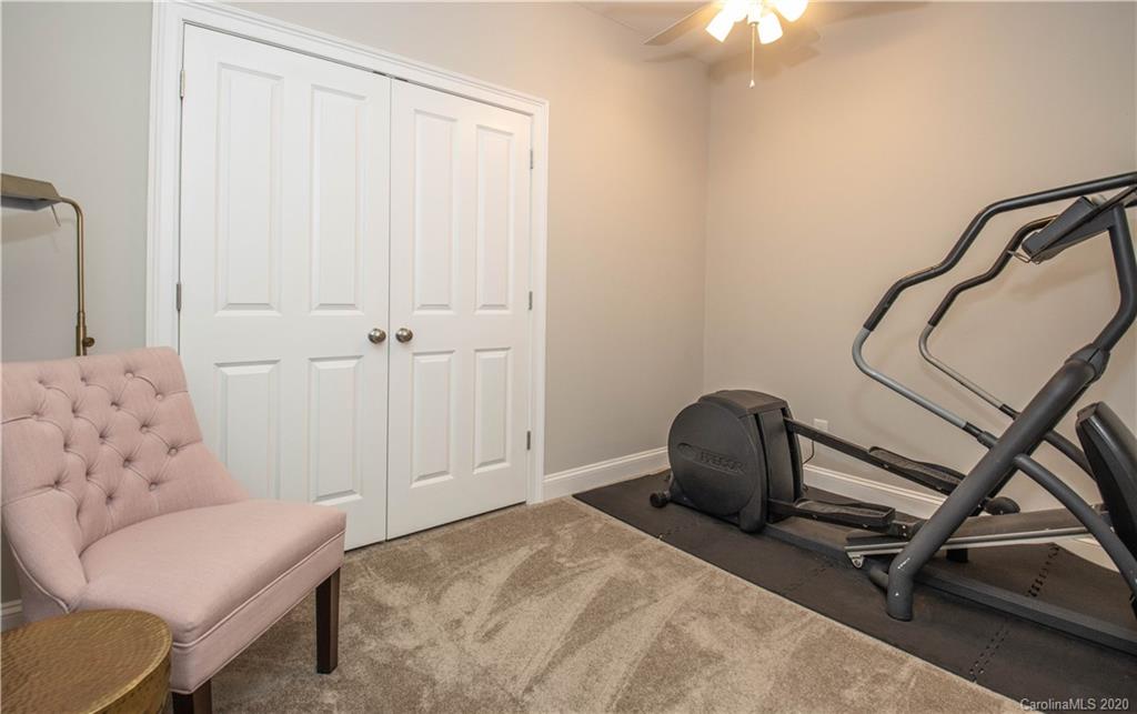 728 Shady Grove Crossing Fort Mill, SC 29708 - Photo 30 of 41 a bedroom with a bed a couch and a window