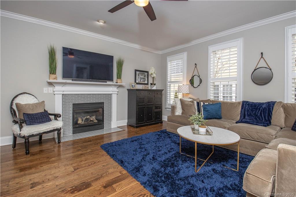 728 Shady Grove Crossing Fort Mill, SC 29708 - Photo 7 of 41 a living room with furniture a flat screen tv and a fireplace