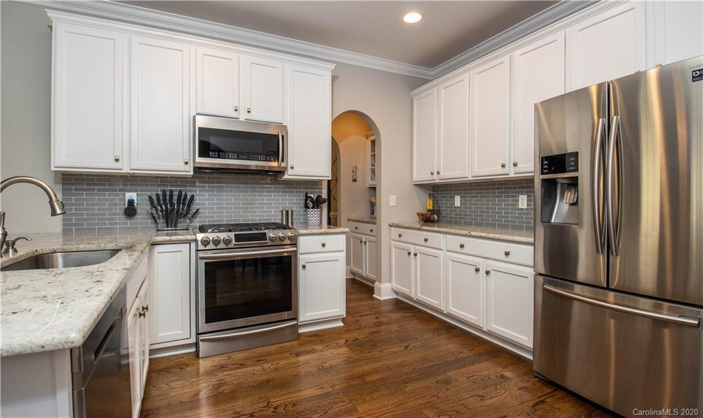 728 Shady Grove Crossing Fort Mill, SC 29708 - Photo 10 of 41 a kitchen with stainless steel appliances granite countertop a stove refrigerator sink and cabinets