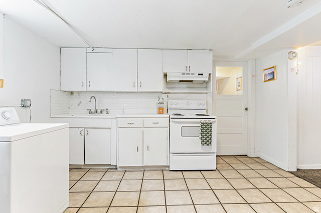 232 300 North Provo, UT 84606 - Photo 18 of 27 Kitchen featuring washer / dryer, white range with electric stovetop, light countertops, white cabinets, and backsplash