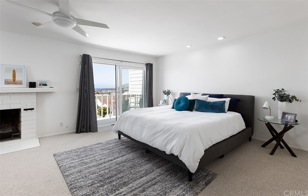 33525 Binnacle Drive Dana Point, CA 92629 - Photo 13 of 76 a bedroom with a large bed and a fireplace