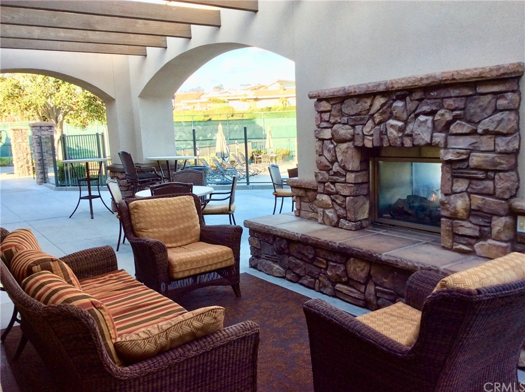 33525 Binnacle Drive Dana Point, CA 92629 - Photo 42 of 76 a living room with furniture a fireplace and a floor to ceiling window