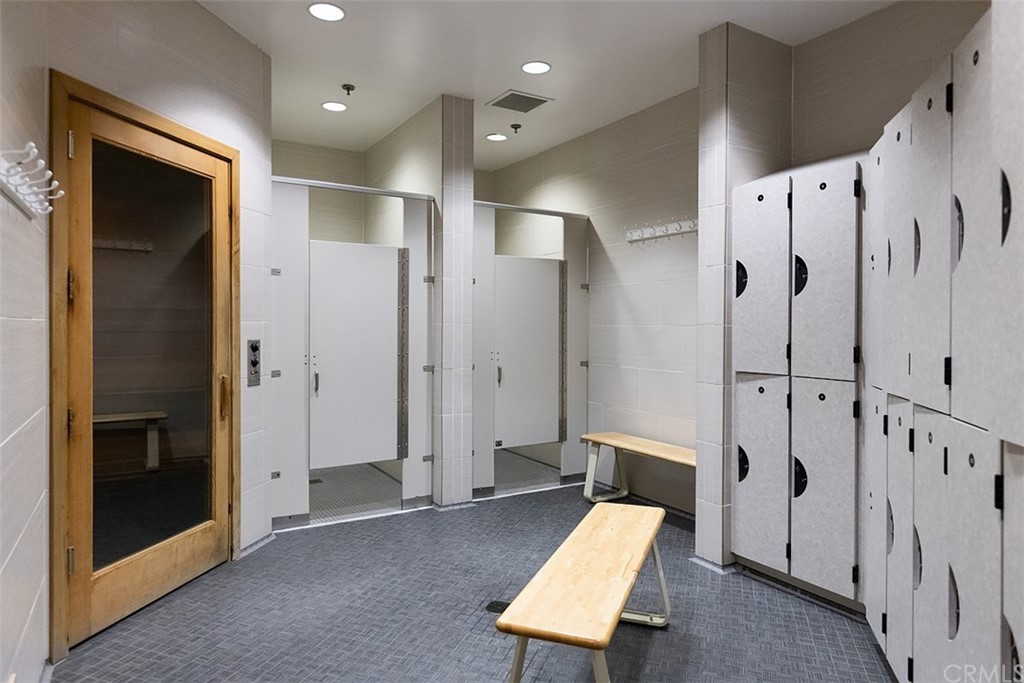 33525 Binnacle Drive Dana Point, CA 92629 - Photo 69 of 76 a walk in closet and a bathroom with glass door shower