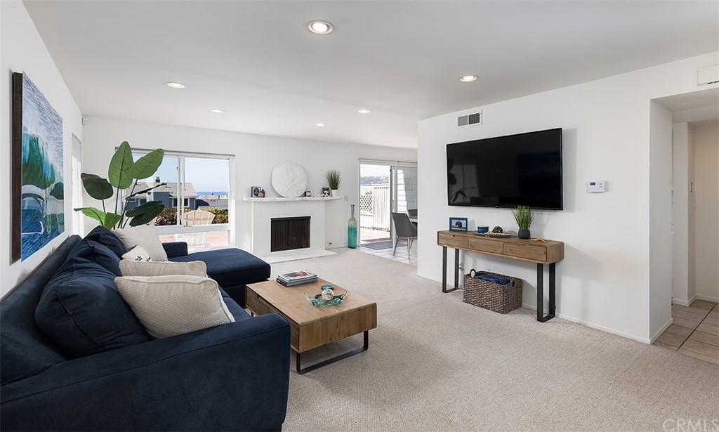 33525 Binnacle Drive Dana Point, CA 92629 - Photo 10 of 76 a living room with furniture a flat screen tv and a fireplace