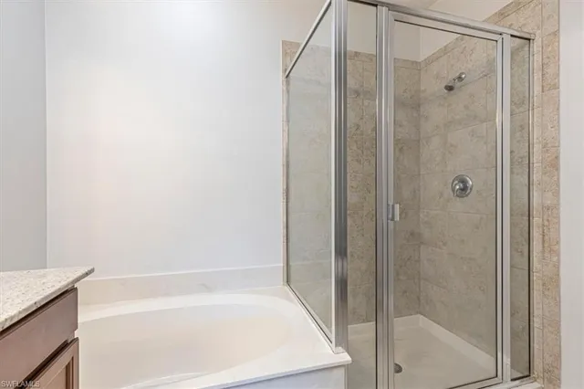 a bathroom with a shower and a bath tub