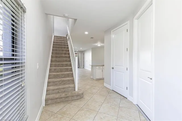 a view of a hallway with stairs and a bathroom