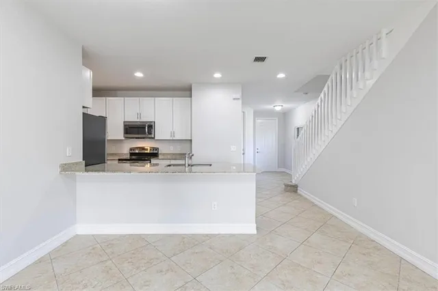 a view of kitchen with sink microwave and stove