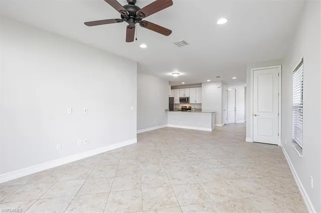 a view of a kitchen with a sink and a refrigerator
